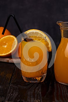 Still life of a glass of fresh orange juice on a vintage wooden table with copy space background