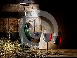 Still-life with glass of wine, bottle and barrel.