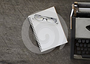 Still life with glasses with book notes and old typing machine vintage style