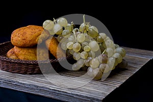 Still life with golden grapes and and paprika bread
