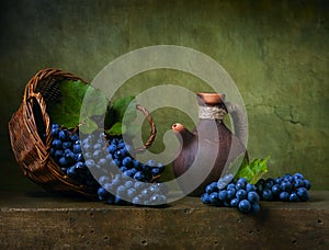 Still life with grapes on a basket photo