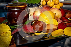 Still life with grapes, nectarines, lemon, jam and autumn leaves. Autumn harvest season. Fresh delicious healthy fruits