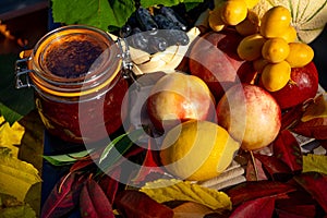 Still life with grapes, nectarines, lemon, unripe dates, jam and autumn leaves. Fresh delicious healthy fruits, contain