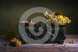 Still life with grapes on vintage scale. photo