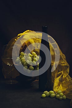 Still life with grapes, wine and yellow cloth