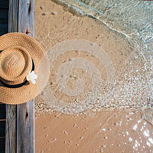 Still life with a hat On the background of clear blue sea water, a beach holiday on the Islands.