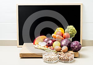 Still life with healthy food and a blackboard with space for copying