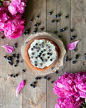 Still-life of homemade pie and fresh peonies