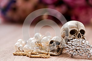 Still life with a human skull with old gold, diamond and jewelry