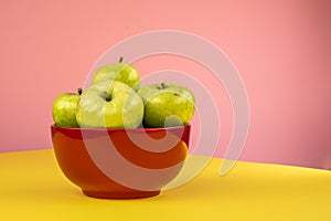 A bowl of green apples