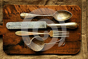 Still life image with old spoon, knife , fork and strainer