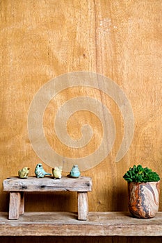 Still life image of Wooden bench and small birds with plant pot on wooden