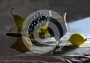 Still life with images of grapes pear lemon and a glass of wine