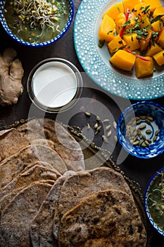 Still life with Indian food on the dark background vertical