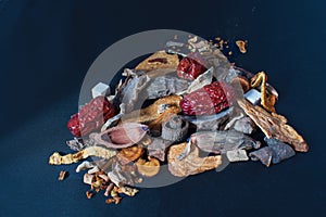 Still life - a layout of chinese herbs lit against a dark background