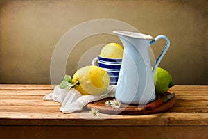 Still life with lemons and blue enamel jug photo