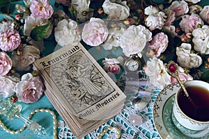 Still life with Lenormand oracle cards, cup and roses