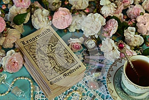 Still life with Lenormand tarot cards, roses and cup