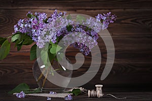 A large bouquet of lilacs on the table. Still life.