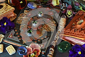 Still life with magic book of spells, runes and wand on witch table