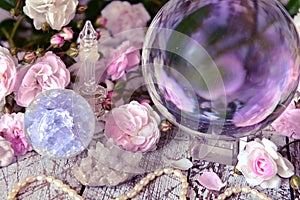 Still life with magic crystal ball, pink roses and necklace photo