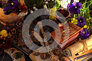 Still life with magic wands, parchments and scrolls with runes on witch ritual table.