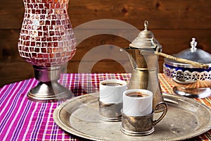 still life with a middle eastern coffee set, on wooden table