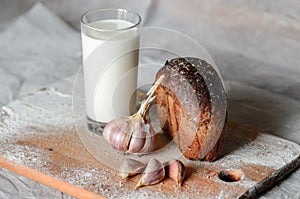 still life of milk, bread and garlic.