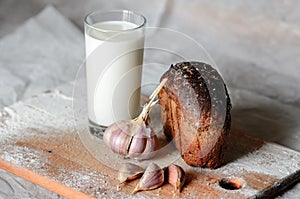 still life of milk, bread and garlic.