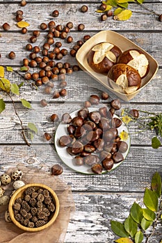 Still life with muffins, ripe chestnuts, hazelnuts, quail eggs