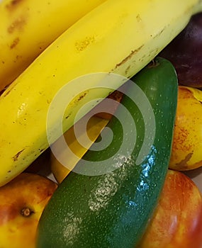 Still life of nectanine plums of bananas avocado