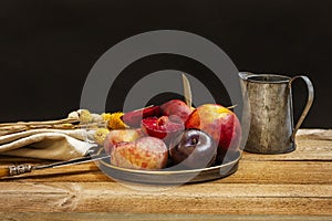 Still life with nectarines, paraguayas and ripe plums