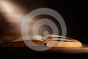 Old book with open pages and ray of light