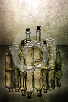 Still life with old glass bottles with reflection