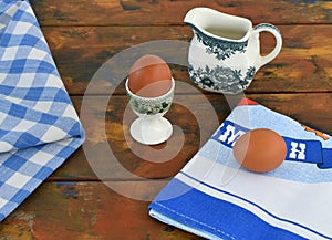 Still life Old wooden table, towel, eggs, farmer creamer.