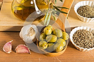 Still life with olives presented in a wooden ladle