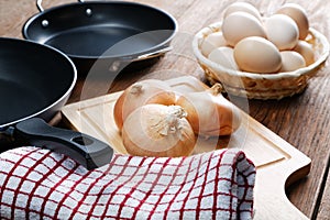 Still-life with onion pans and eggs