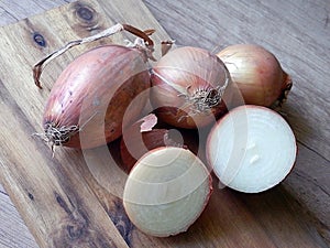 Still life with onions on vintage wooden desk.