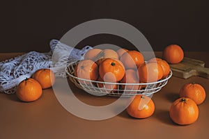 Still life orange in the basket on the black background. food and fruit abstract.