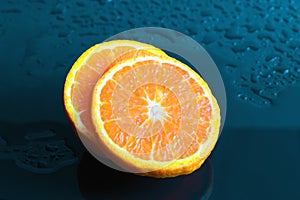 Still life Orange slice fruit on dark blue background. mandarins