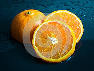 Still life Orange slice fruit on dark blue background. mandarins