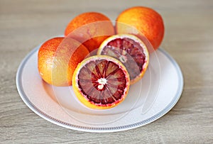 Oranges in the plate - tarocco blood orange - sanguine orange - red orange photo