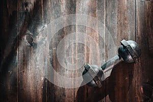 Still life overhead shot of grunge steel dumbbells on wooden flo