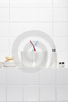 Still life of pair of toothbrushes conveying togetherness in white bathroom