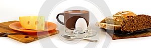 Still life panorama with egg, cheese and bread