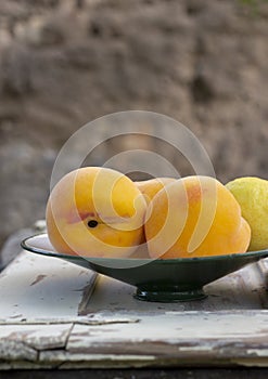 Still life of peaches and lemon