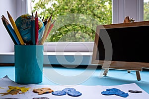 Still life of pencils, a globe and a blackboard. Knowledge Day concept.