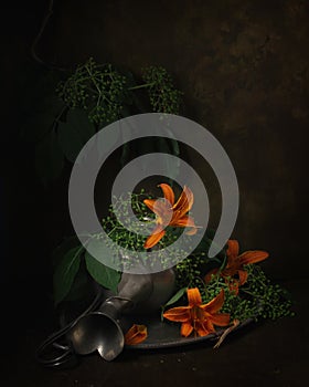 Still life with a pewter jug, lilies and green berries