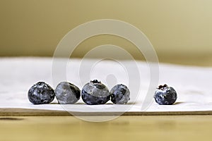 Row of blueberries on a white table cloth