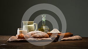 Still life photo of bread and flour with milk and eggs